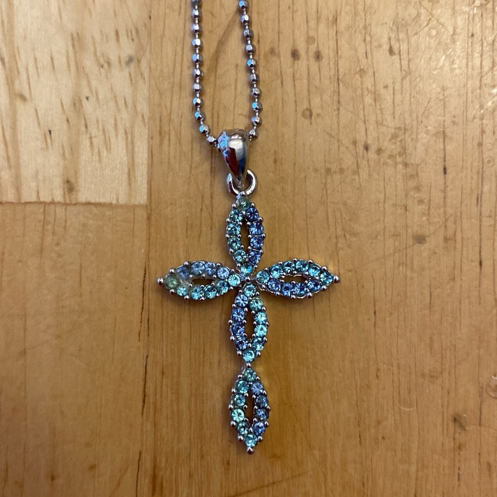 Elegant Silver tone Cross Pendant Necklace with blue crystals. Chain about 16 in